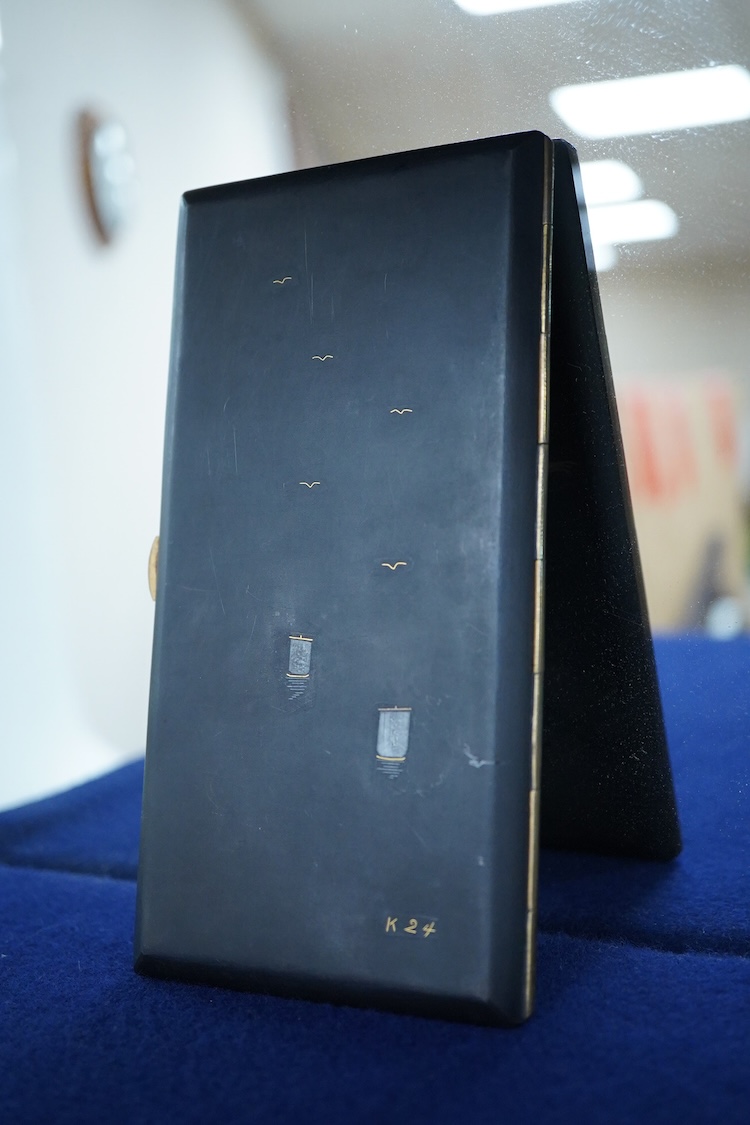 A Japanese photograph album, late 1940's to include banknotes and a telegram, together with a cigarette case